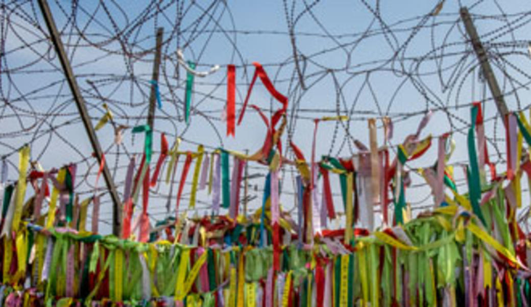 Buddhist peace flags on barbed wire