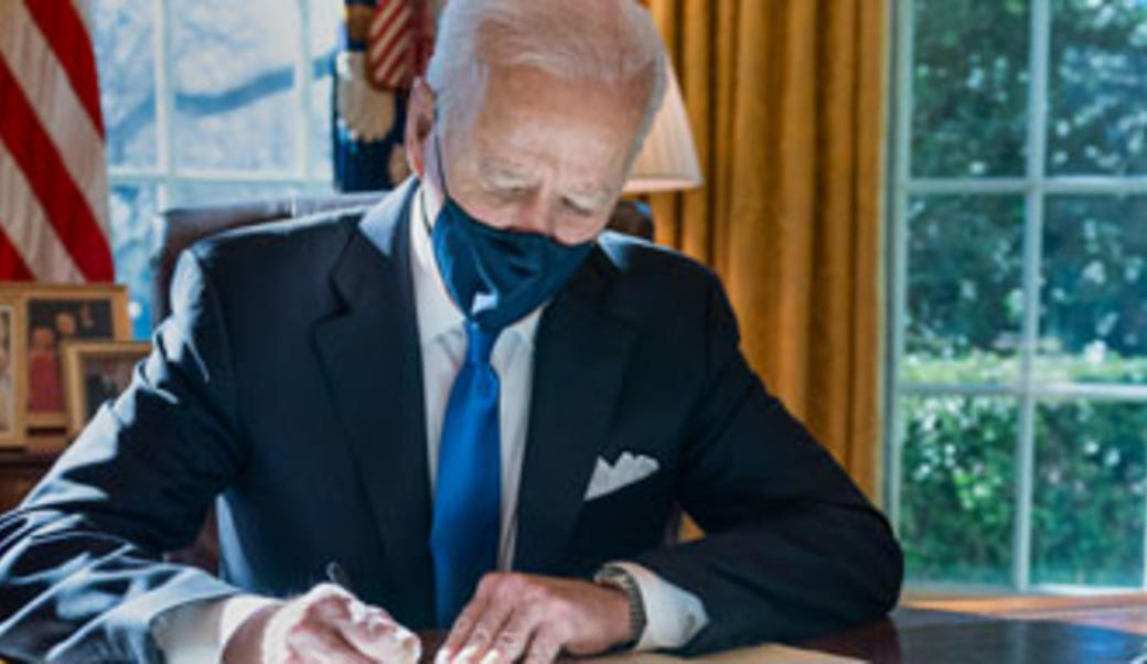 Joe Biden signing a bill