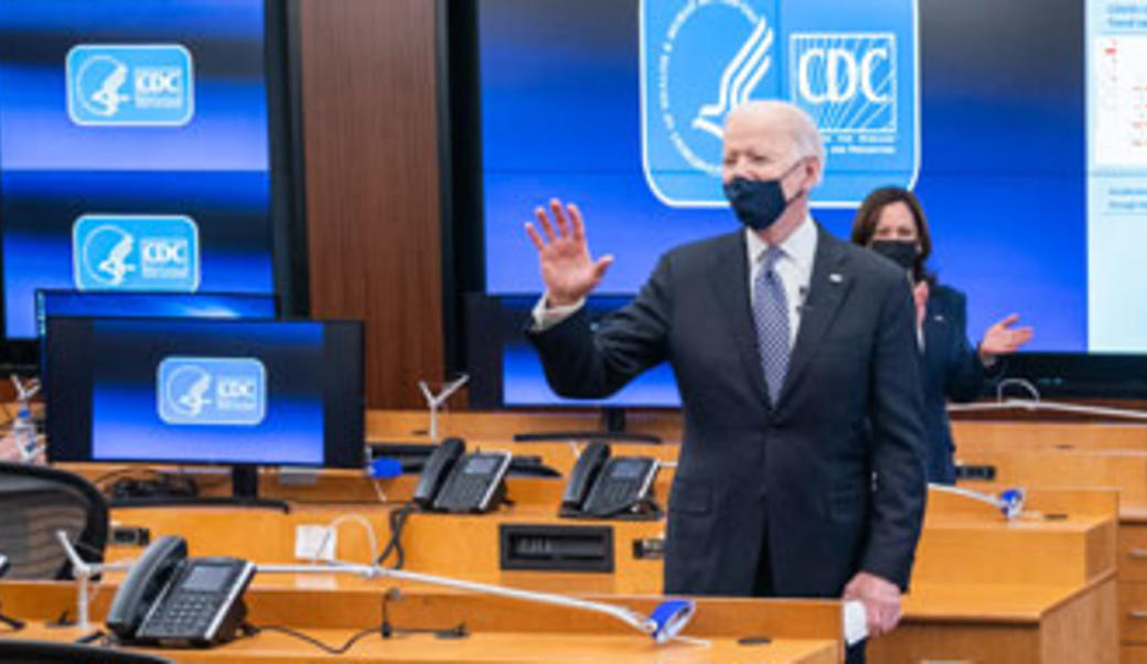 Joe Biden at CDC with hand raised