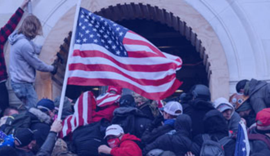 Washington, DC - January 6, 2021: Rioters clash with police trying to enter Capitol building through the front doors