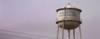 Water tower against purple sky