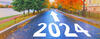 2024 painted on road with arrow pointing ahead